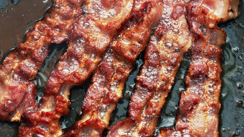Close up of cooked bacon in a pan