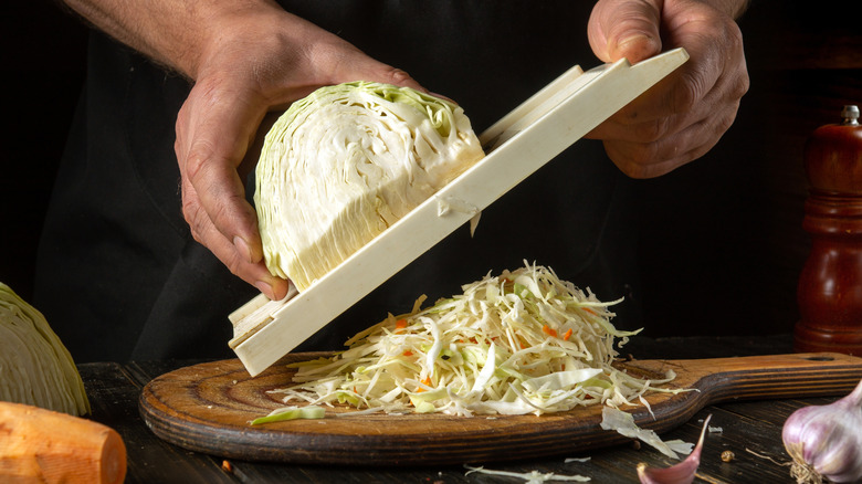 Cabbage being shredded with a mandoline
