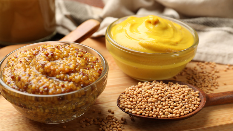 Different types of mustard in clear bowls