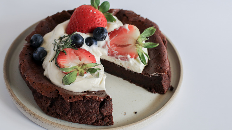 Chocolate cake with whipped cream and fruit