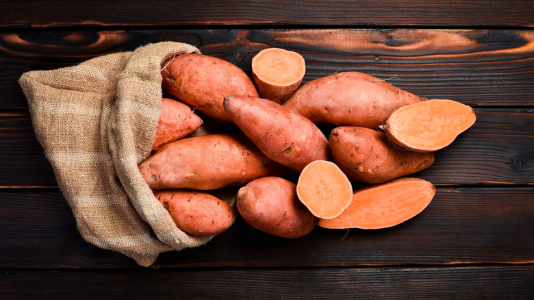 Sweet potatoes spilling from sack