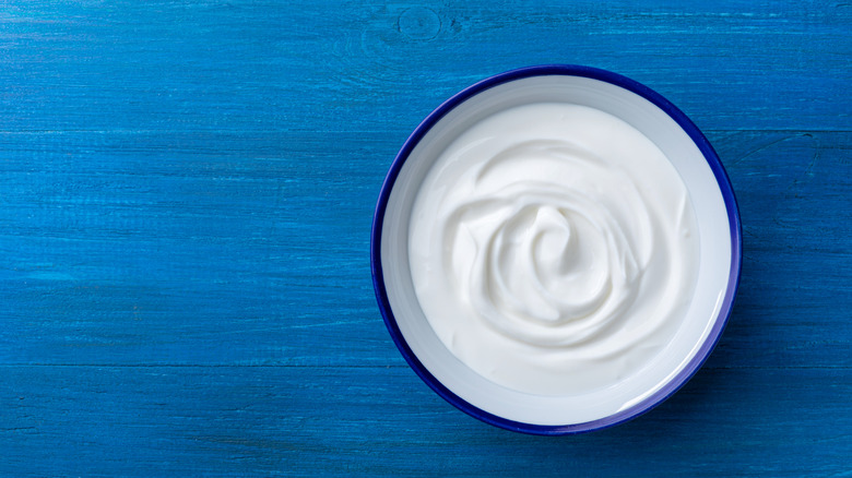 greek yogurt in a bowl on a blue table