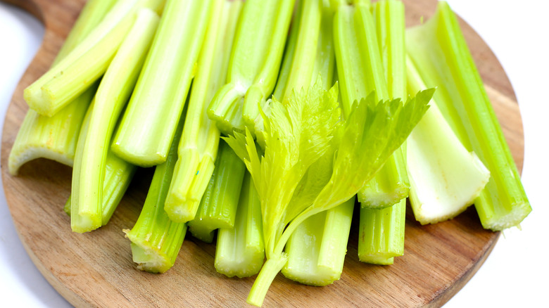 celery stalks on a wooden plate