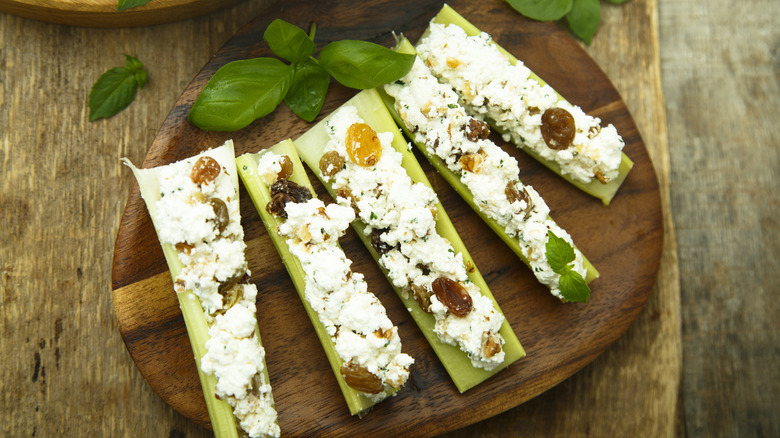 stuffed celery on a wooden platter