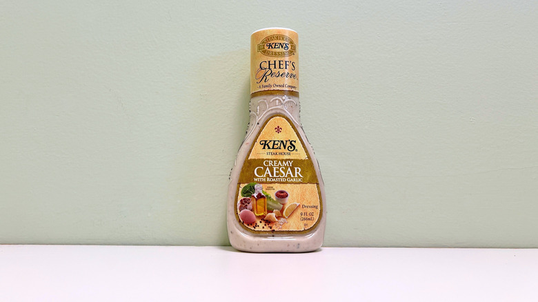 Ken's Steak House roasted garlic Caesar dressing bottle on counter.