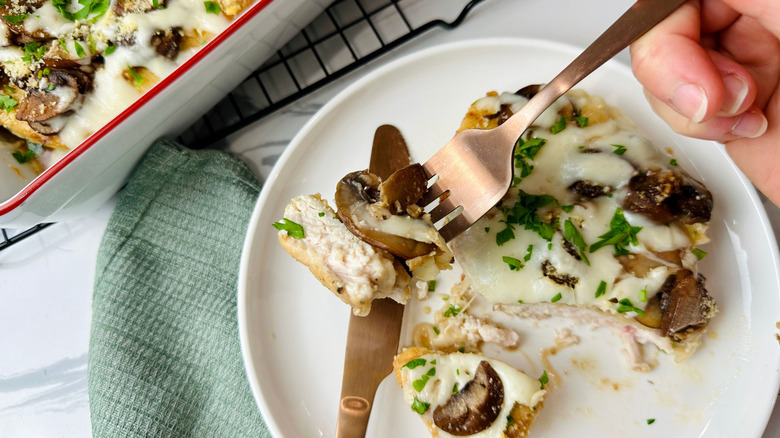 Bite of chicken Lombardy on fork