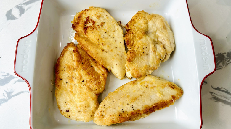cooked chicken breasts in a white pan