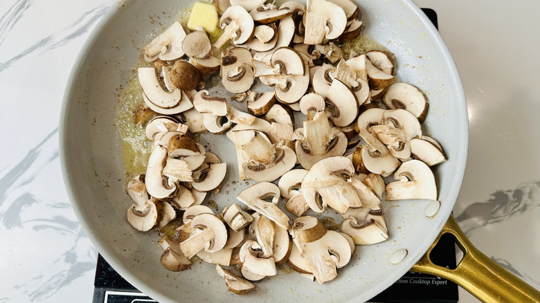 raw mushrooms in a frying pan