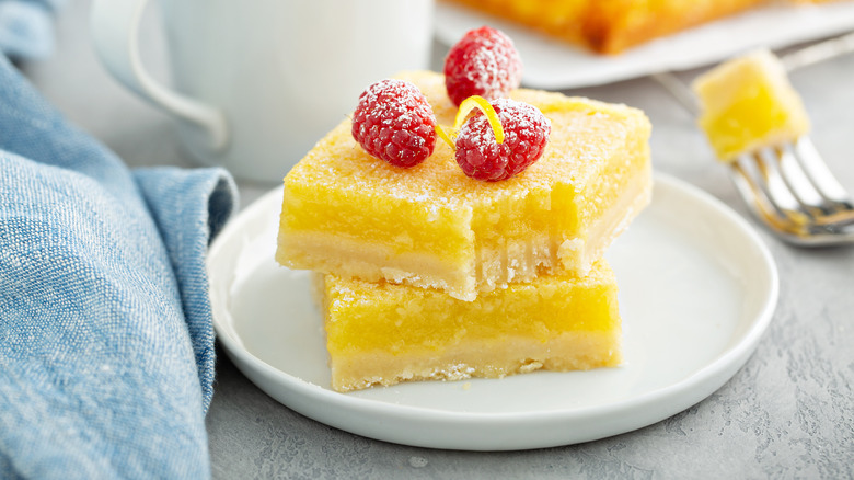 Lemon squares with powdered sugar and raspberries