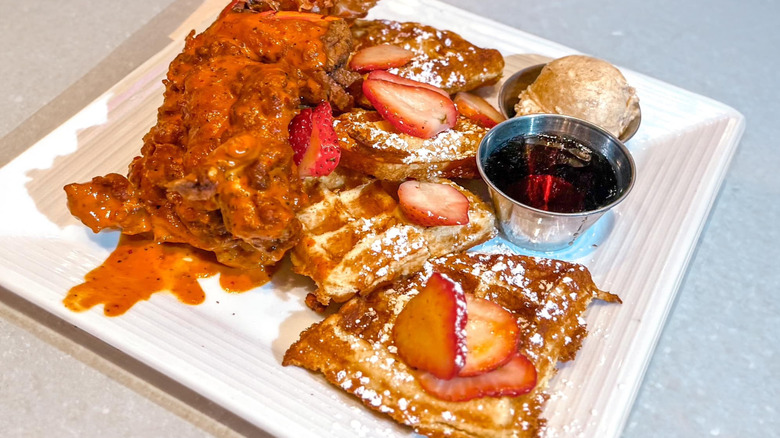 Plate of chicken and waffles with strawberries