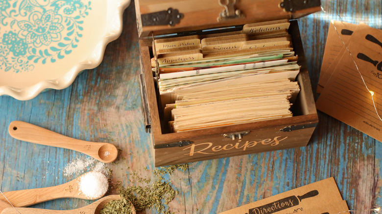 Wooden recipe box and ingredients on a table