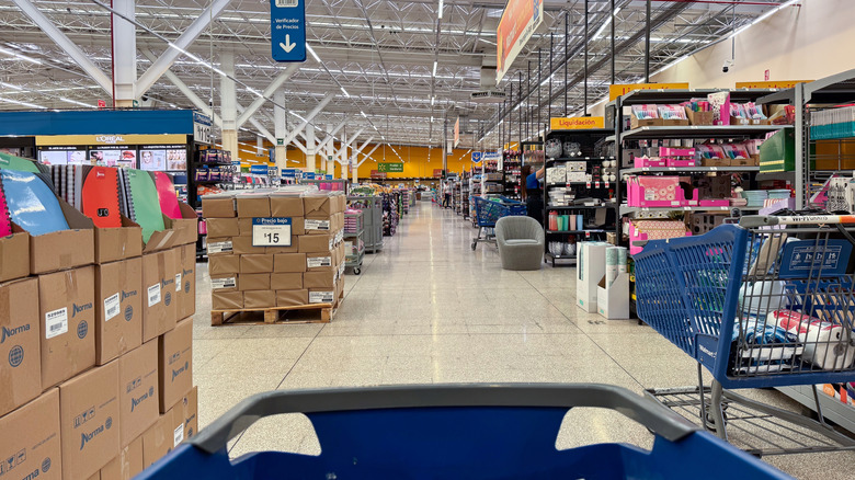 A blue grocery cart moving through a Costco