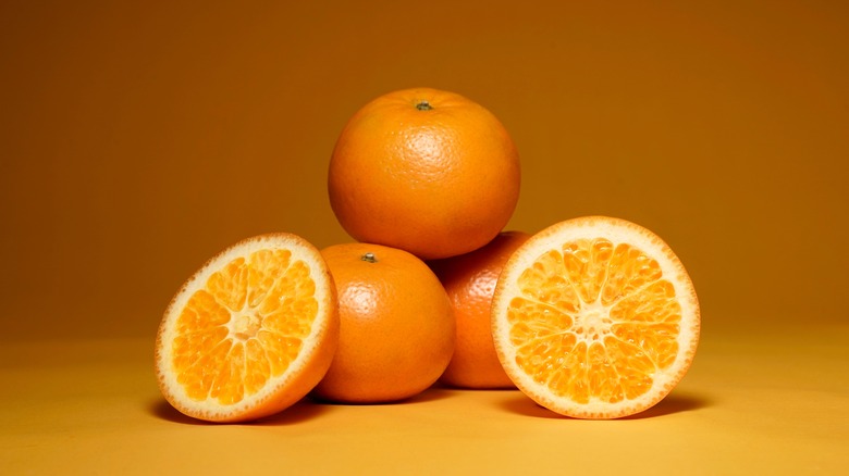 Whole and halved oranges