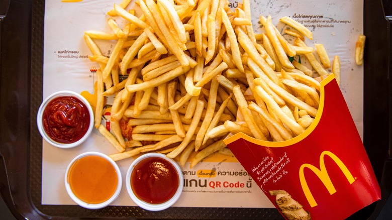 McDonalds fries next to several sauces