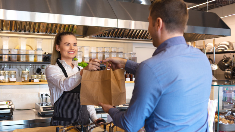 Restaurant worker giving to-go order