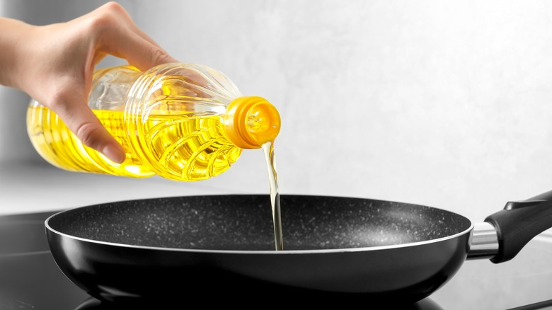 pouring frying oil into a pan