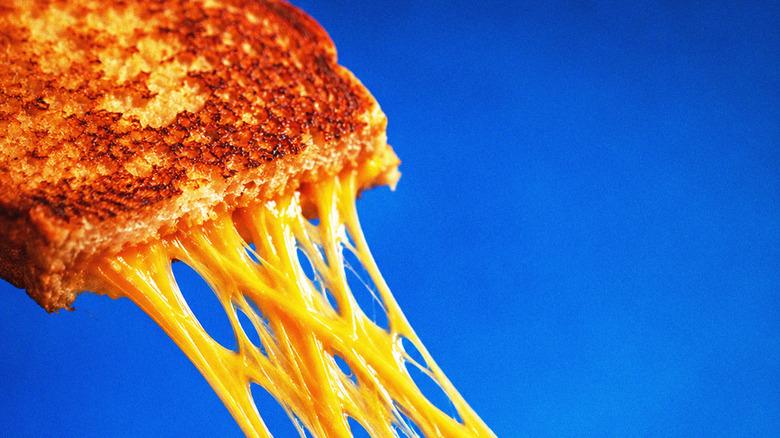 Melty cheese pulling away from a crispy cheese sandwich