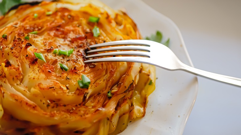 Roast cabbage steak with fork