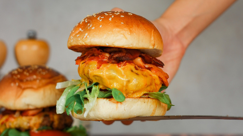 Burger filled with kimchi, bacon, and cheese