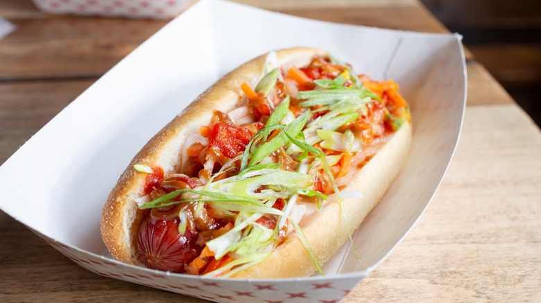 kimchi hot dog served in disposable container