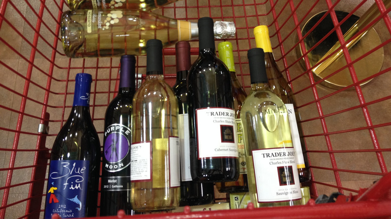 bottles of wine piled in a Trader Joe's shopping cart