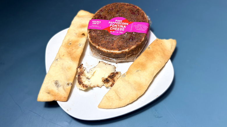 trader joes pink peppercorn cheese on plate with flatbread crackers
