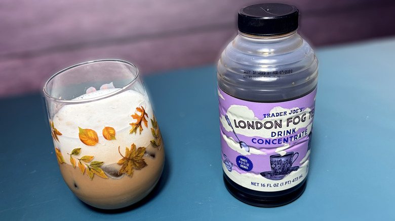 bottle of trader joes london fog tea concentrate next to london fog latte in glass