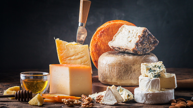 various cheeses on a wooden board