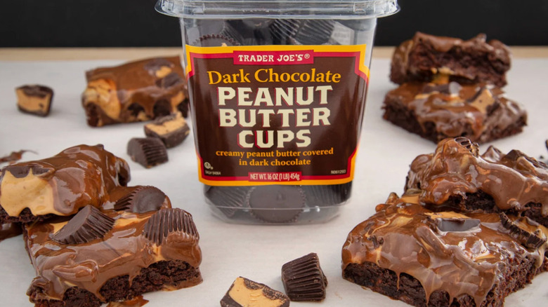 A package of Trader Joe's Dark Chocolate Peanut Butter Cups next to brownies and candies
