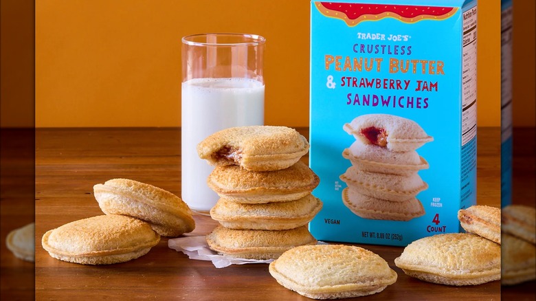 Toasted Trader Joe's Crustless Peanut Butter & Strawberry Jam sandwiches with box and glass of milk.