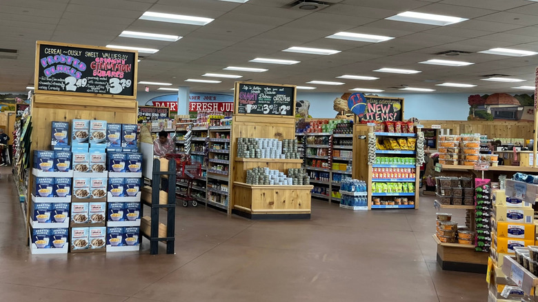 A woman on the NYC subway with a Trader Joe's tote bag on her shoulder