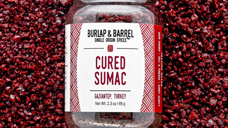 Bottle of sumac sitting on sumac