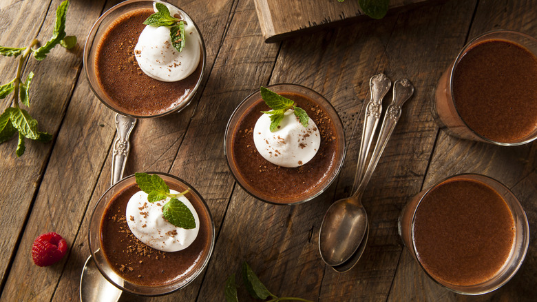 Two chocolate mousse desserts in glass cups