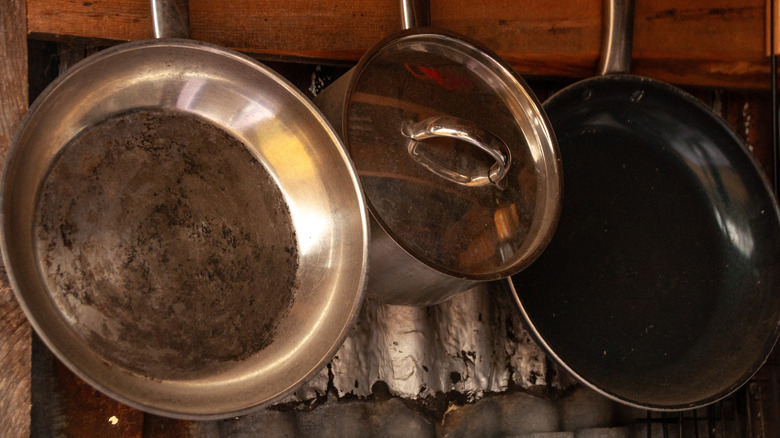Old frying pans hanging in kitchen