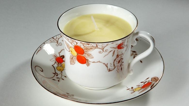 A teacup containing a candle