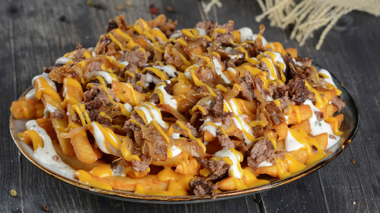 Close up of loaded fries with beef and cheese