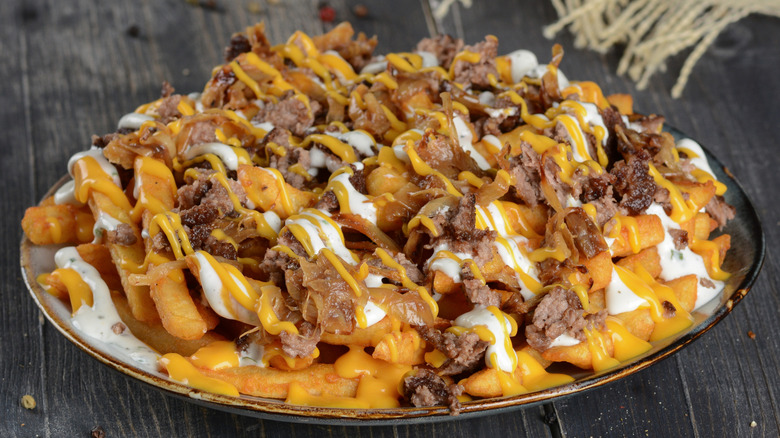 Close up of loaded fries with beef and cheese