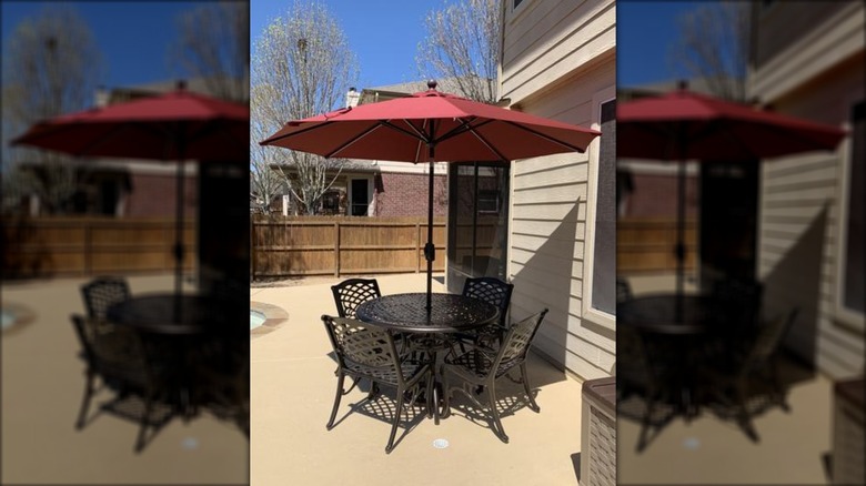 Noble House Sarasota 5-piece cast aluminum set with an additional red umbrella
