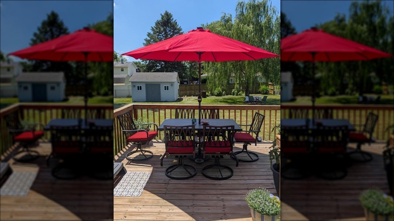 Nuu Garden 7-piece metal set with cushioned swivel chairs and an additional red umbrella
