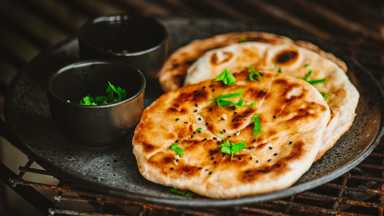 Naan flatbread on a plate topped with cilantro