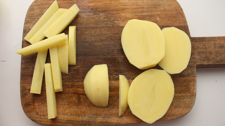 potato slices on cutting board 