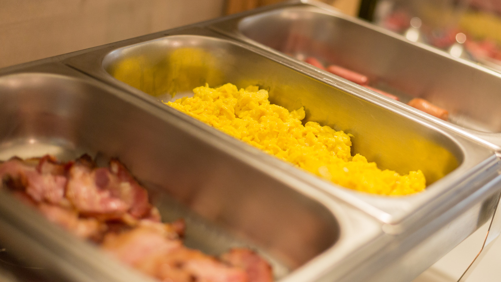 hotel scrambled eggs being served at a breakfast counter
