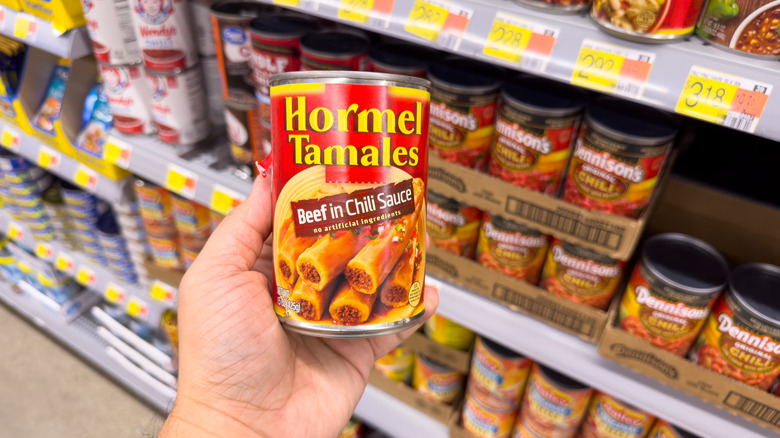 Hand holding can of tamales