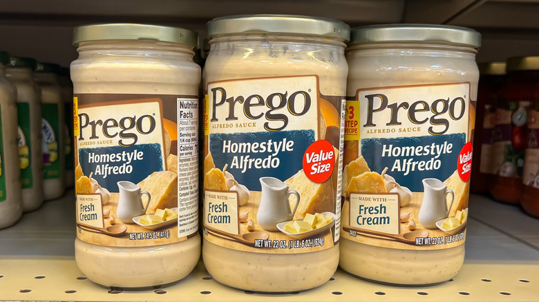 Jars of Alfredo sauce on a shelf