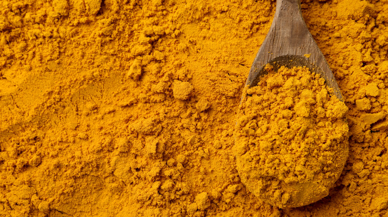 curry powder and a wooden spoon