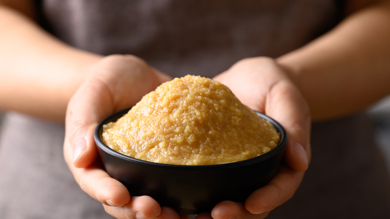Person holding soybean paste