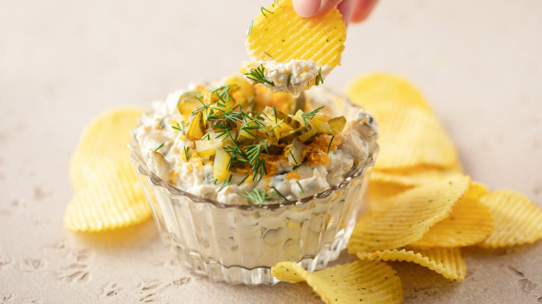 pickle dip in a glass bowl with chips