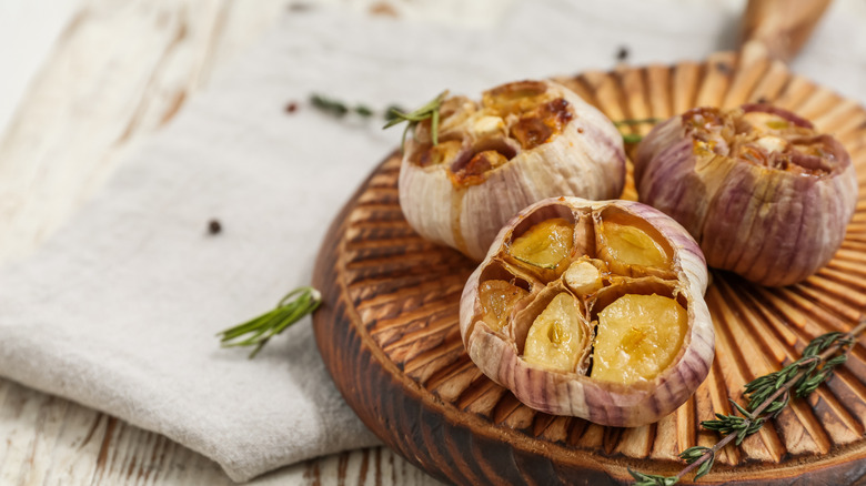 Platter of three roasted garlic heads
