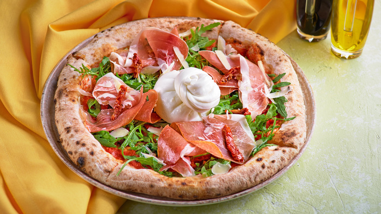 Burrata and prosiutto pizza