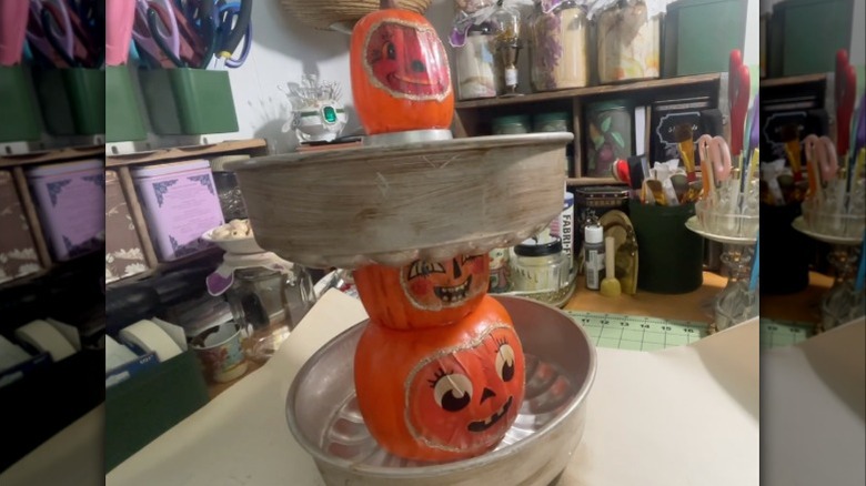 A tiered bundt cake stand made with pumpkin ornament supports